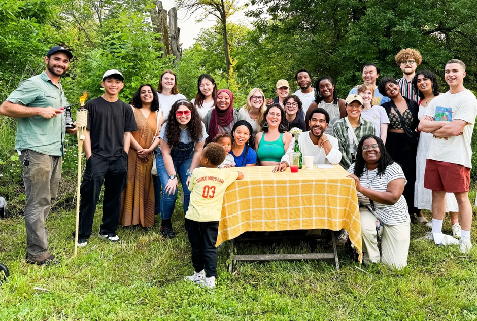 A group of community members behind a table at Sanctuary Farms
