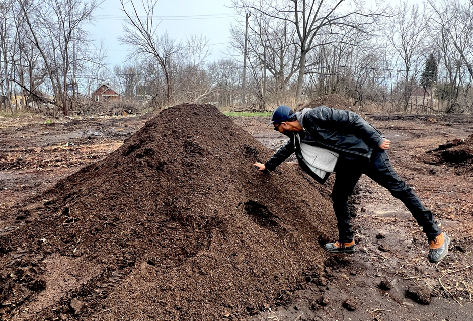 jøn kent touching a pile of compost